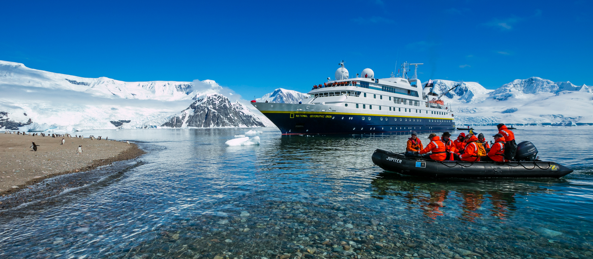 An expedition ship in an Antarctic landscape